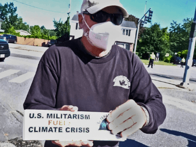 Image of member holding Bumper sticker